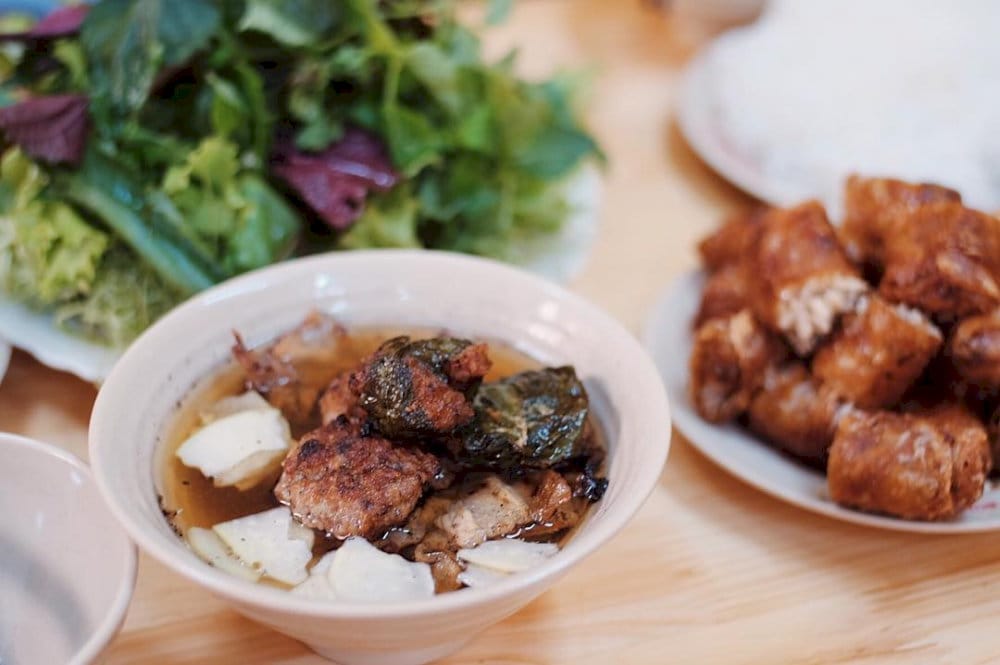 Delicious grilled pork with crispy crab spring rolls, perfectly balanced by the tangy dipping sauce and pickled veggies
